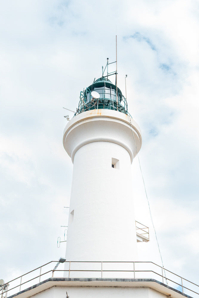 White lighthouse against a cloudy sky