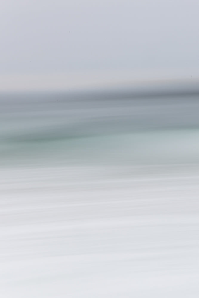 Abstract image with horizontal lines of varying shades of gray and white, suggesting a blurred landscape or a minimalist design.