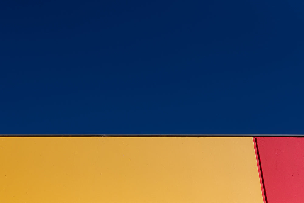 Abstract geometric pattern showing primary colors against sky