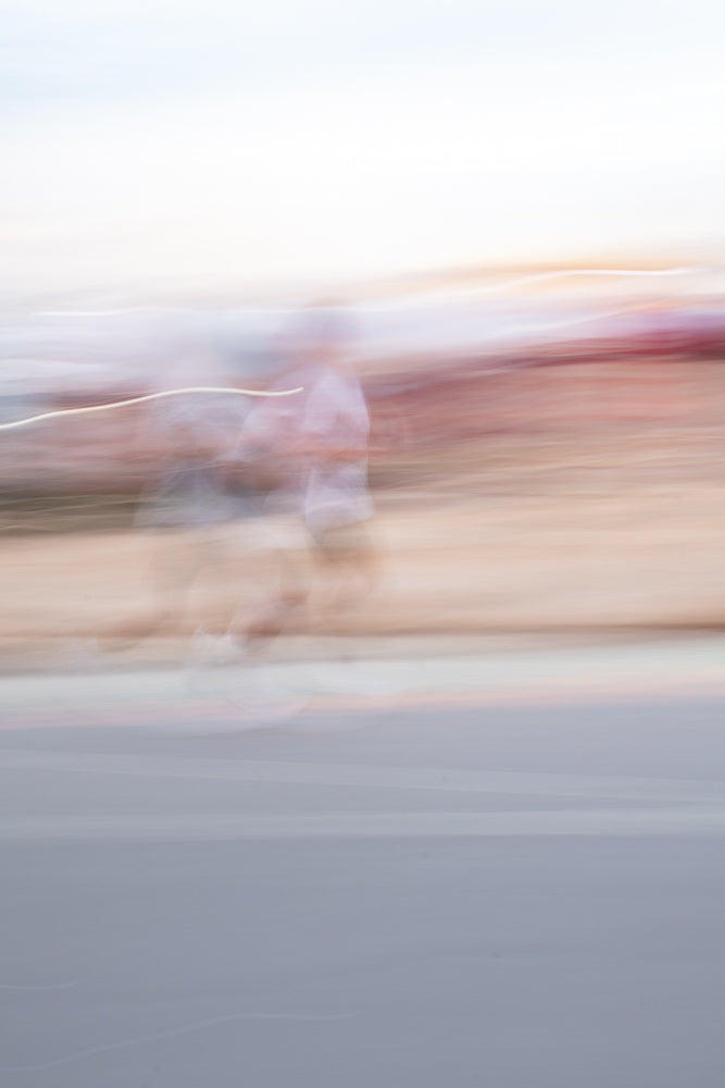 Runner creating motion blur effect on street