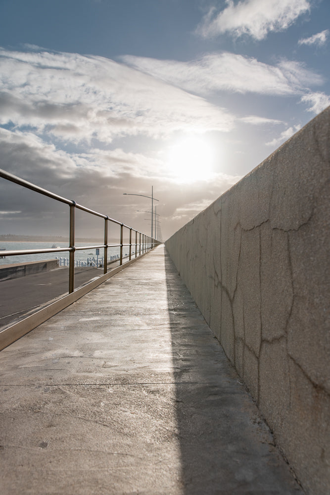 Coastal walkway in bright morning light, leading lines