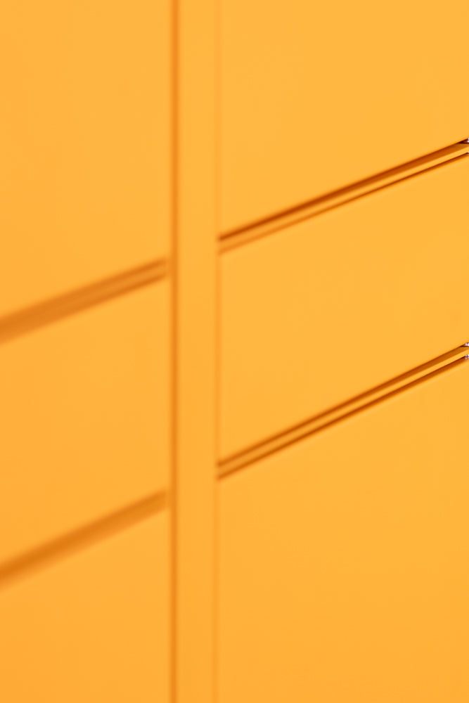 Abstract shot of a bright yellow surface with horizontal indentations