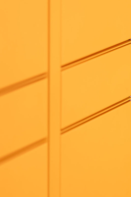 Abstract shot of a bright yellow surface with horizontal indentations