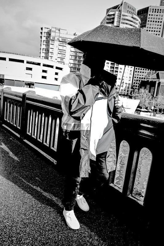Person holding umbrella on a rainy day in the city.