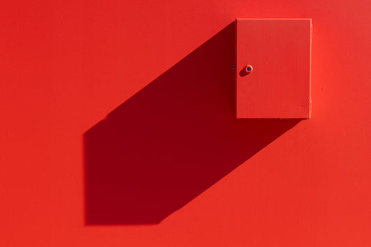 Red box on wall casting geometric shadow