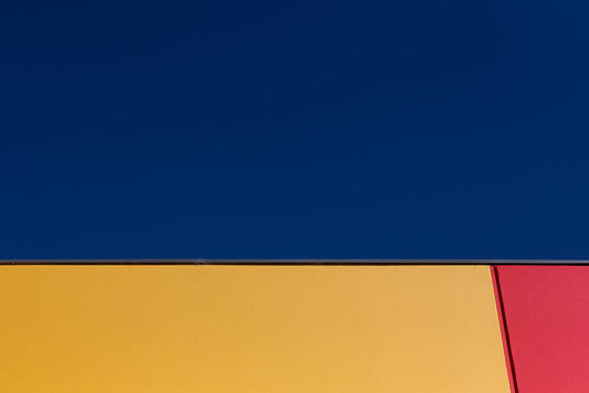 Abstract geometric pattern showing primary colors against sky