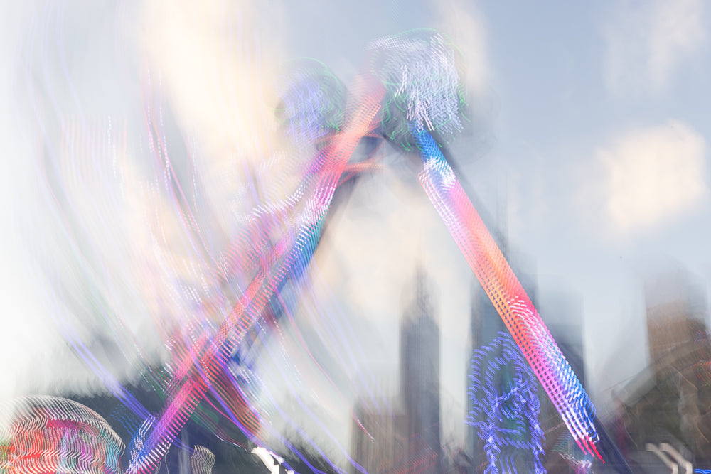 Colorful light trails from an amusement park ride