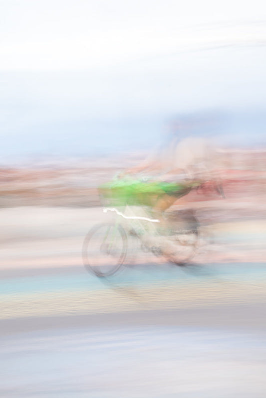 Cyclist moving fast with dreamy pastel motion blur