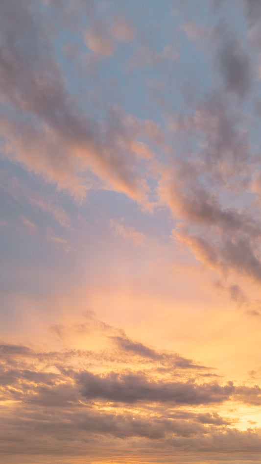Sunset clouds painted in hues of orange and pink.