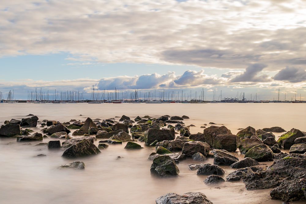 St Kilda at soft pastel Sunset over rocks towards the marina and Bay