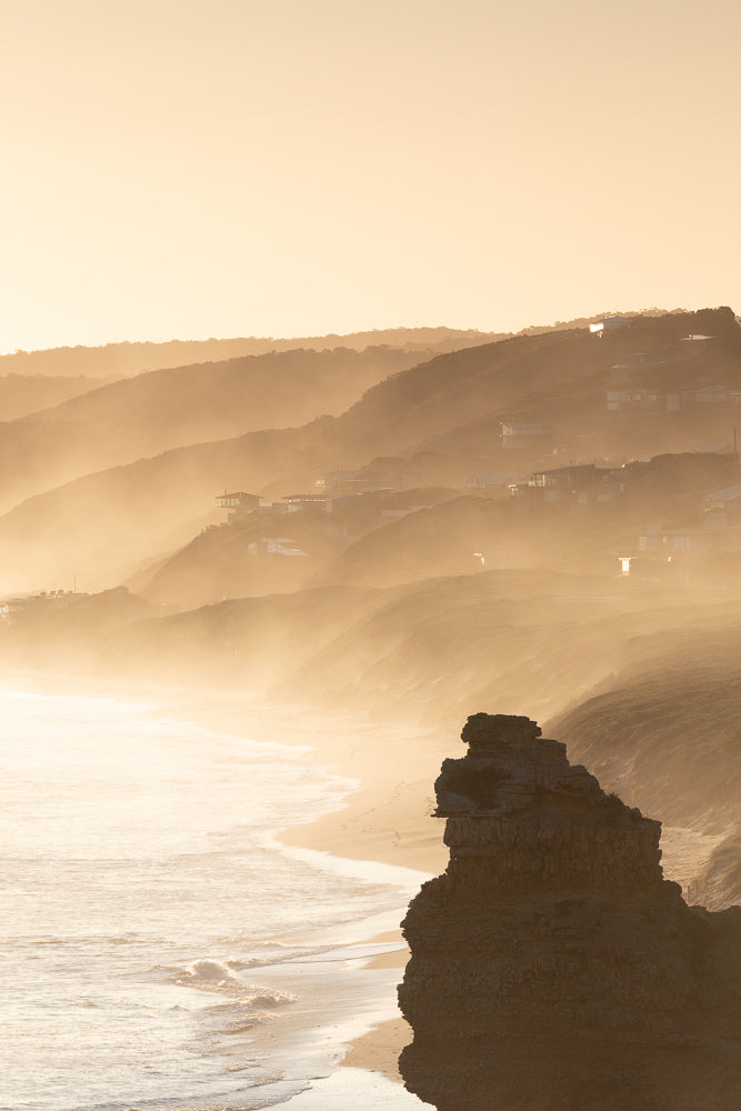 Hazy Golden Sunset over beach with silhouette rock Aireys Inlet