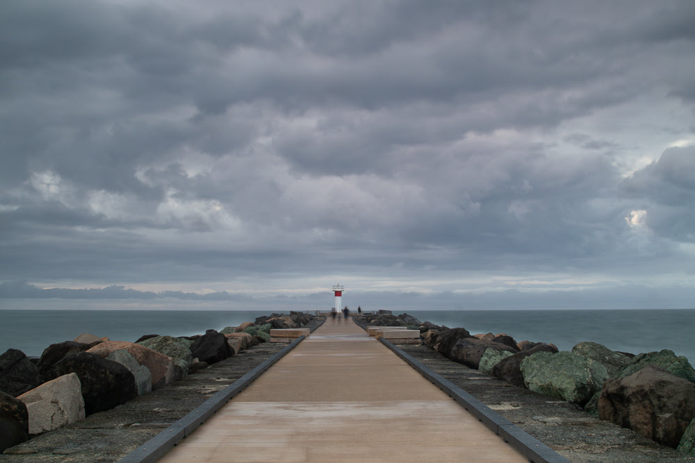 Stormy breakwater path leading to a lighthouse - The Spit, Gold Coast
