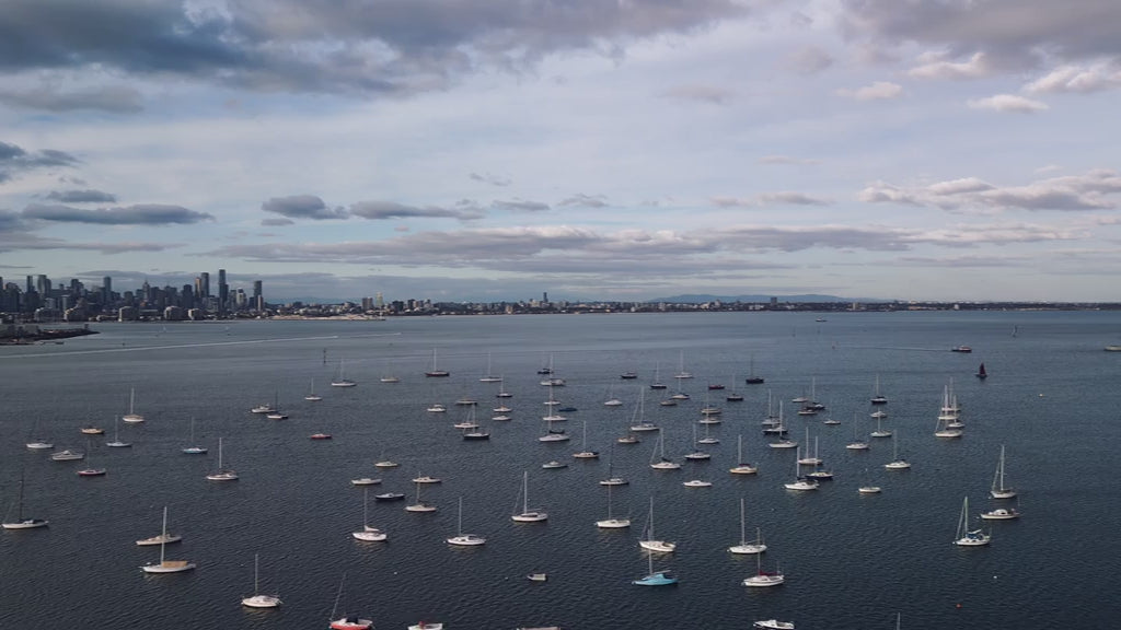 Aerial view of yachts anchored in marina with Melbourne skyline