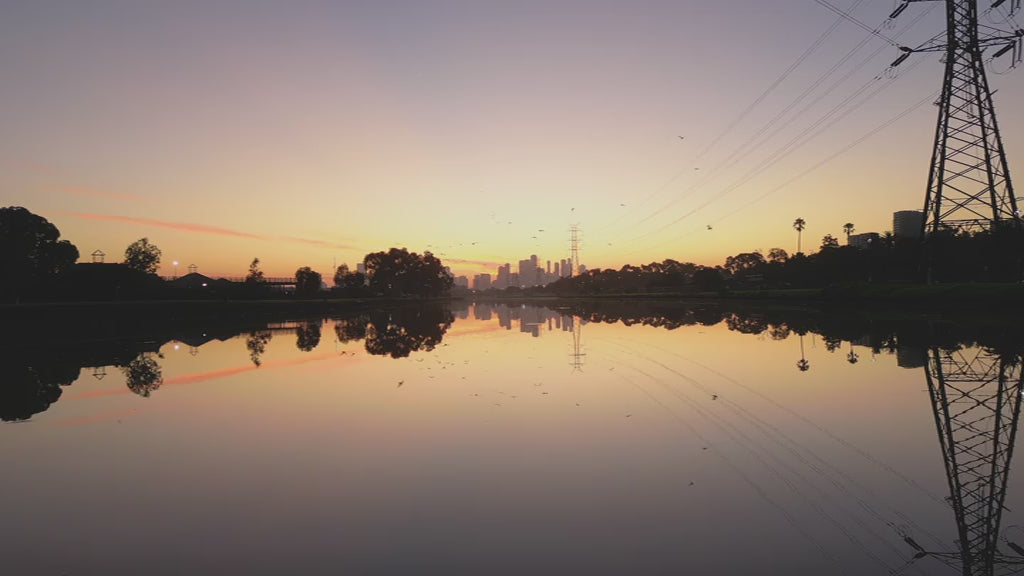 Melbourne CBD Reflections on Maribyrnong River at Sunset with birds flying