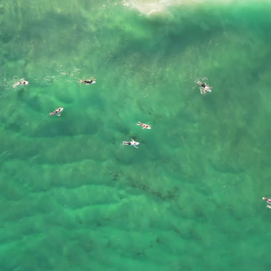 Top-down aerial view of surfers waiting for waves on the Gold Coast