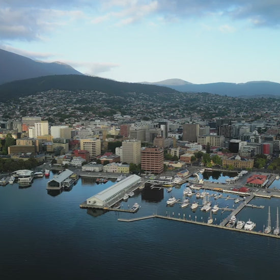 Aerial Hobart Harbour Waterfront and town day slow flying left