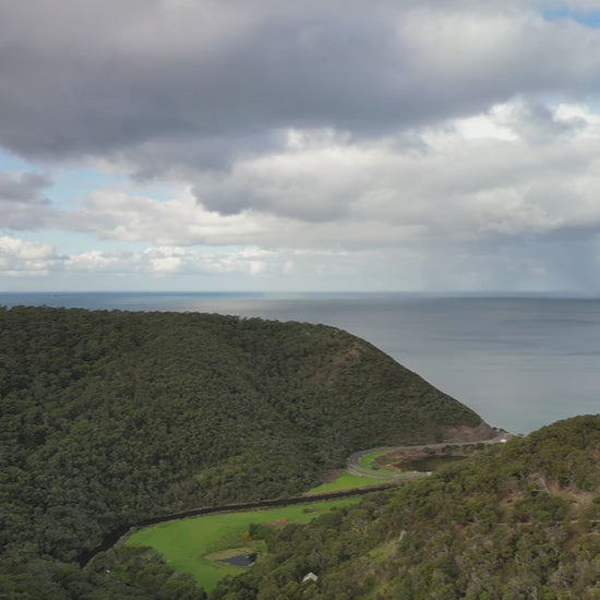 Great Ocean Road near Lorne. Aerial elevalte up over St George River from Otways Mountains to ocean over Lorne Scenic Beach. High-quality 4k footage