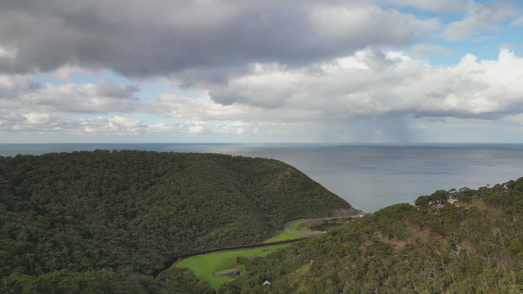 Great Ocean Road near Lorne. Aerial elevalte up over St George River from Otways Mountains to ocean over Lorne Scenic Beach. High-quality 4k footage