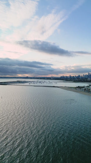 Aerial fly over Port Phillip Bay to reveal Melbourne skyline and St.Kilda bayside
