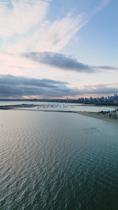 Aerial fly over Port Phillip Bay to reveal Melbourne skyline and St.Kilda bayside