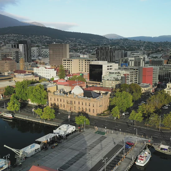 High fly out from Hobart town over Harbour marina - day