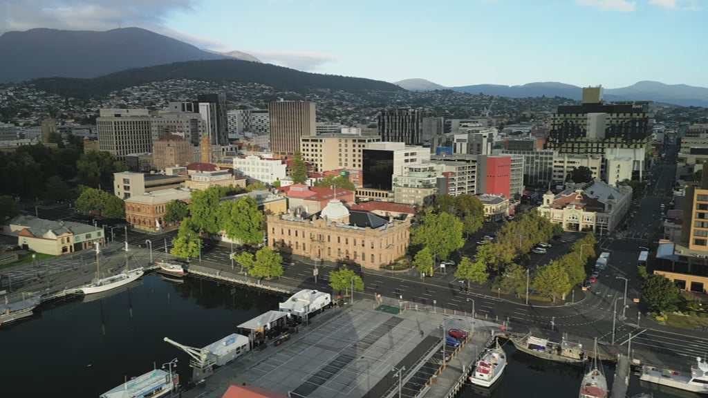 High fly out from Hobart town over Harbour marina - day