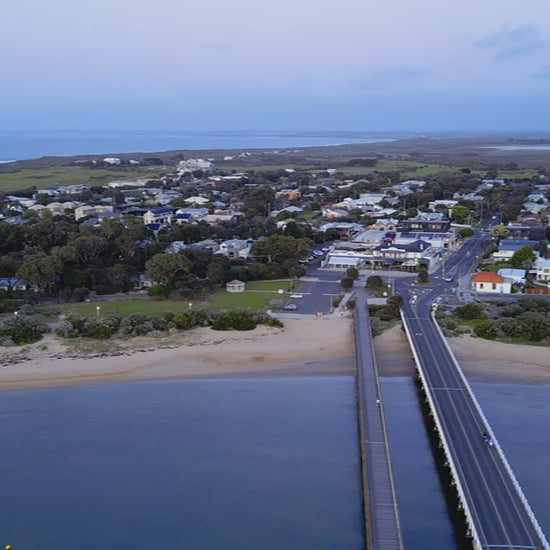 Aerial Barwon Heads Bridge to town at dusk, view from above