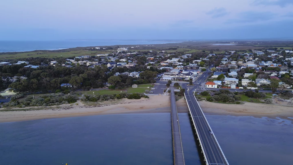 Aerial Barwon Heads Bridge to town at dusk, view from above