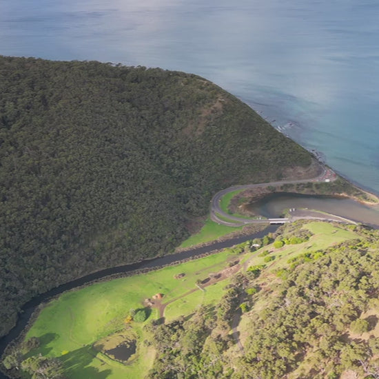 Great Ocean Road near Lorne. Aerial track along St George River from Otways Mountains to ocean over Lorne Scenic Beach. High-quality 4k footage