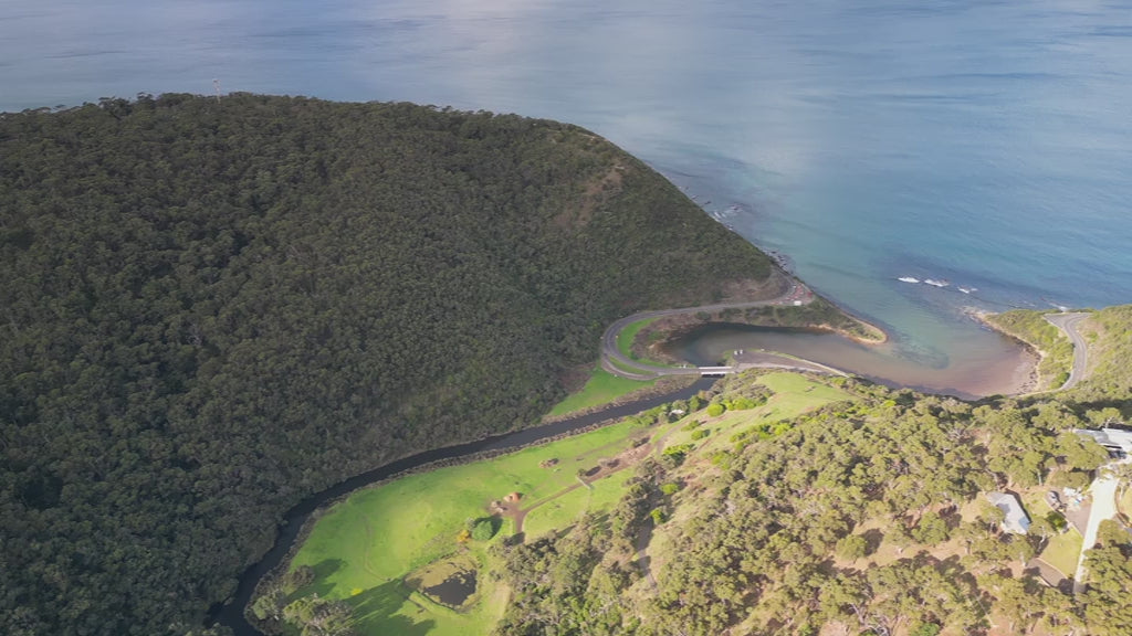 Great Ocean Road near Lorne. Aerial track along St George River from Otways Mountains to ocean over Lorne Scenic Beach. High-quality 4k footage