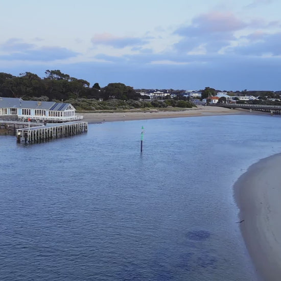 Aerial Barwon Heads Bridge and townscape captured from above at dusk