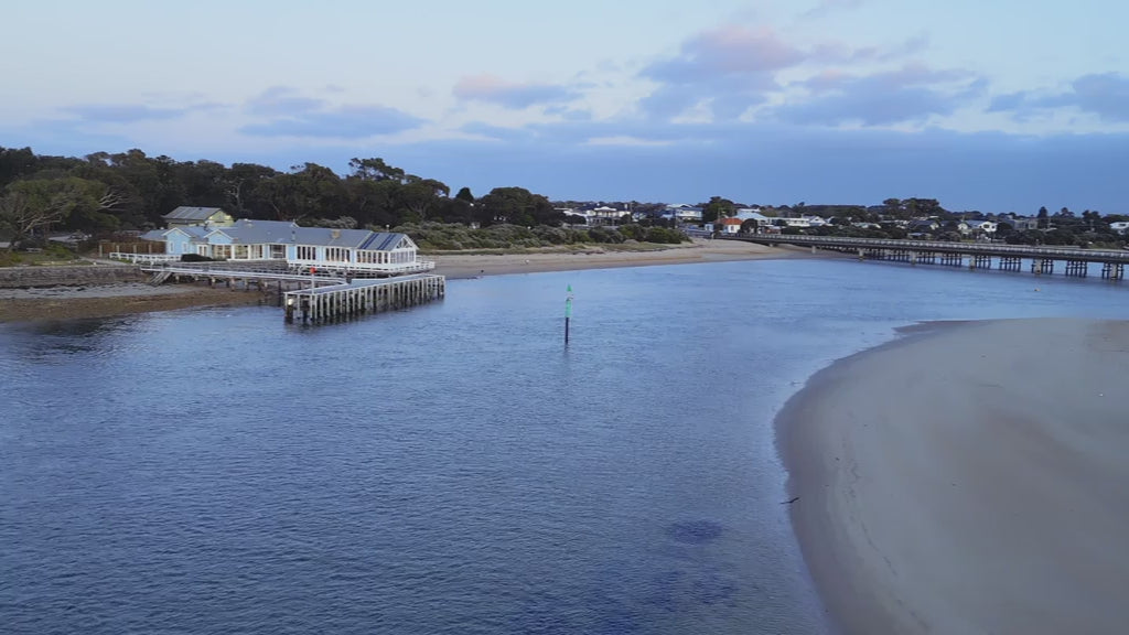 Aerial Barwon Heads Bridge and townscape captured from above at dusk