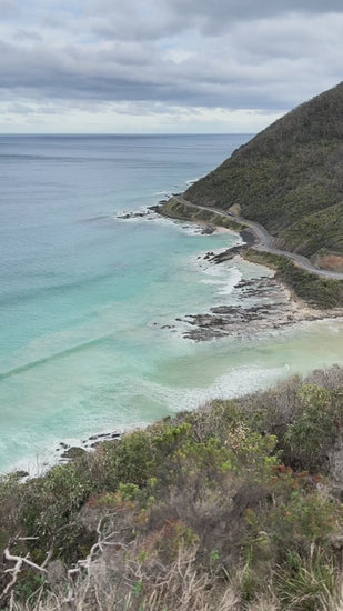 Great Ocean Road along turquoise ocean on cloudy day with waves