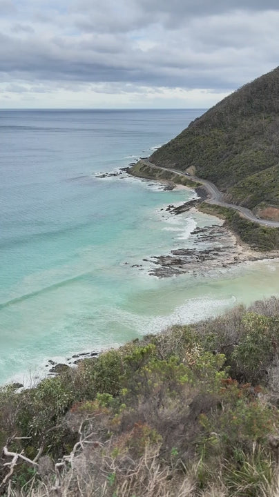Great Ocean Road along turquoise ocean on cloudy day with waves