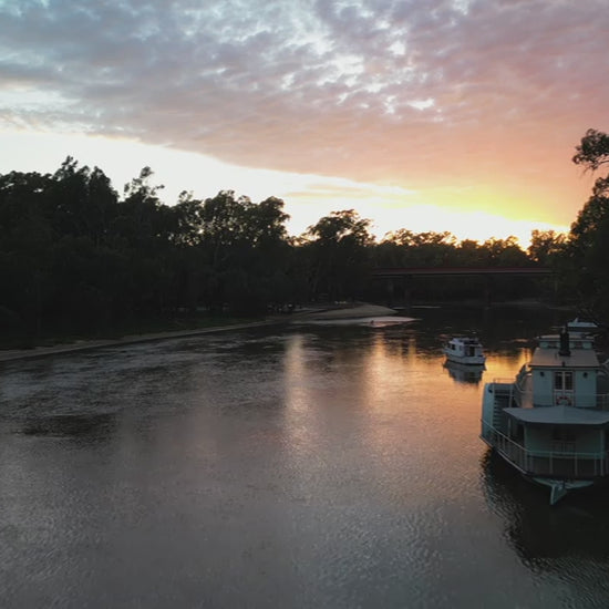 Travel along Murray River at sunset - paddle-boarder, boats - Victoria Australia. High quality 4k footage