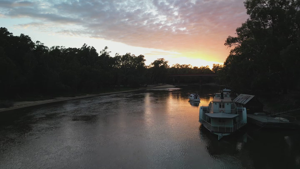 Travel along Murray River at sunset - paddle-boarder, boats - Victoria Australia. High quality 4k footage