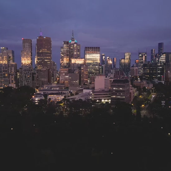 Aerial view of Melbourne skyline at sunrise, flying towards the city