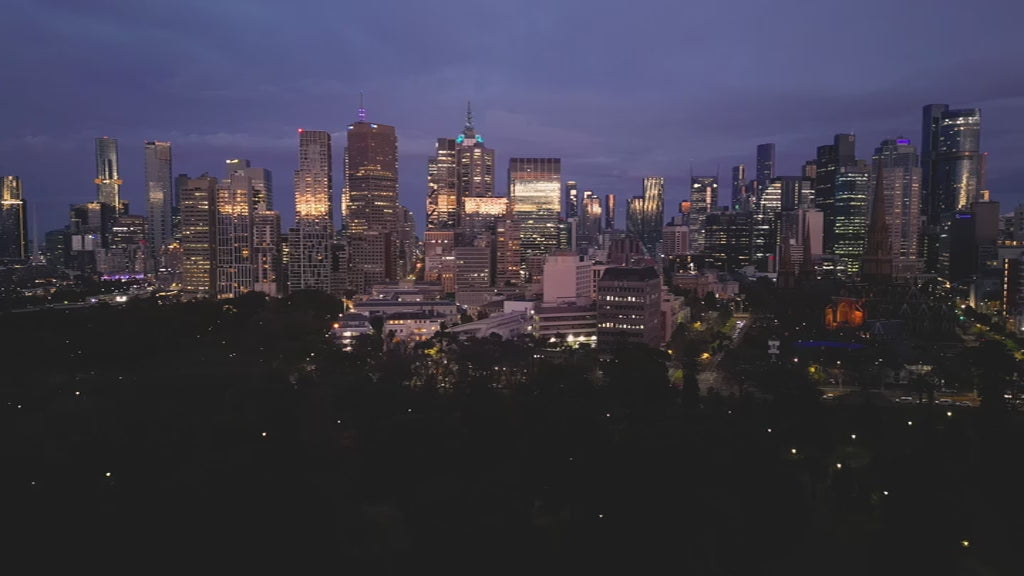 Aerial view of Melbourne skyline at sunrise, flying towards the city